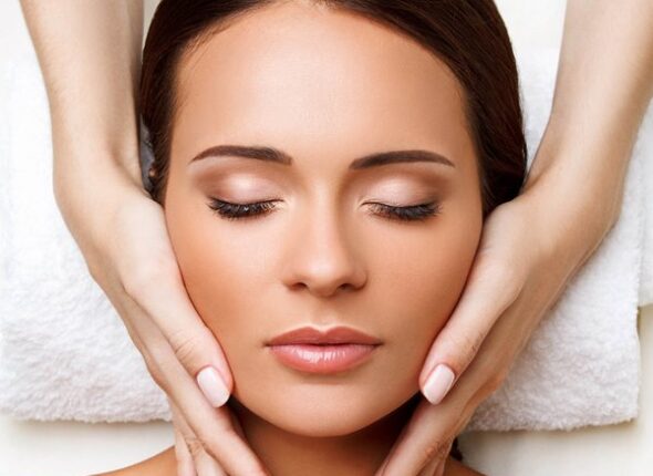 Face Massage. Close-up of a Young Woman Getting Spa Treatment.